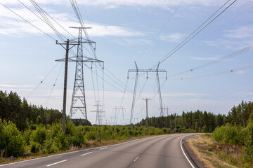 High voltage power lines over a road in Finland