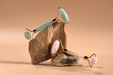 Roller massagers made of jade and rose quartz are modern tools for skin care. Modern composition with natural stones for the beauty industry