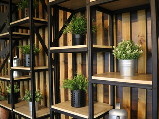 decorative split-level shelves with flowers in pots to create an atmosphere of eco-coziness, cozy decor with potted greenery on shelves made of wood and metal