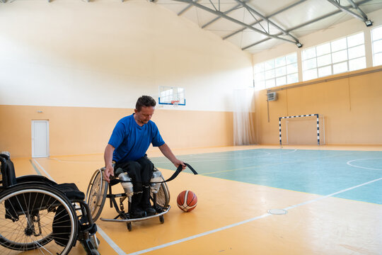 a handicapped basketball player prepares for a match while sitting in a wheelchair.preparations for a professional basketball match. the concept of disability sport