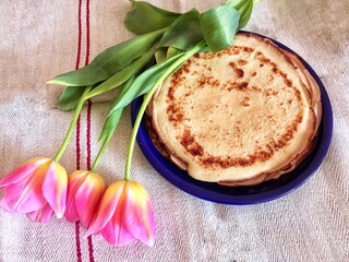 homemade pancakes and tulips on the table 