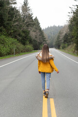 future concept. highway road among forest with walking girl.