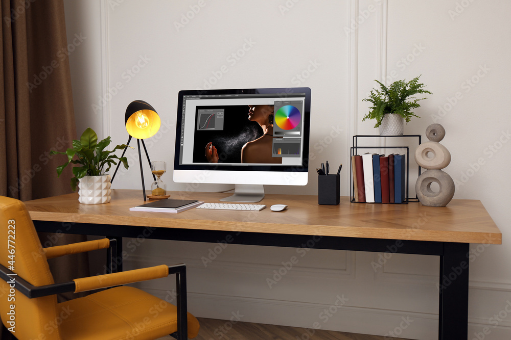 Poster designer's workplace. computer with photo editor application on table indoors