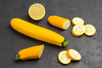 Ripe yellow zucchini, sliced zucchini, half lemon