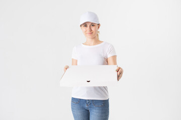 Female delivery woman in white uniform holding white boxes of pizza. Mock-up.