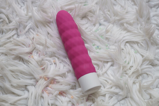 Pink dildo on a furry background