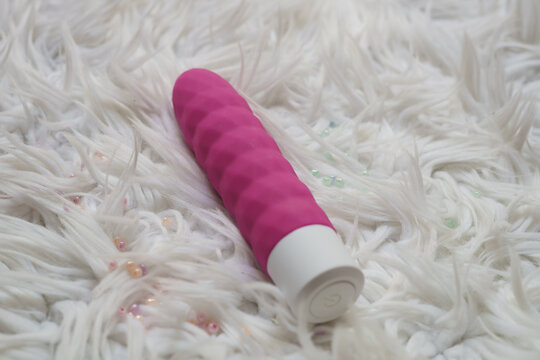 Pink dildo on a furry background