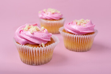 Strawberry cupcakes on a pink background. Strawberry yogurt cupcakes on a solid background.