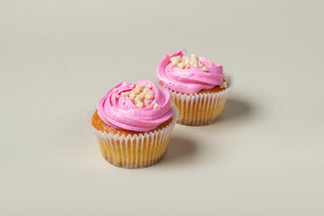 Strawberry cupcakes on a light background. Strawberry yogurt cupcakes on a solid background.