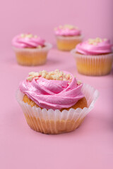 Strawberry cupcakes on a pink background. Strawberry yogurt cupcakes on a solid background.