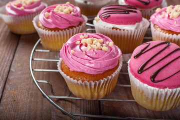 Strawberry cupcakes on a wooden background. Strawberry yogurt cupcakes for tea. Sweets with tea.