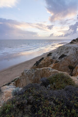 Fototapeta na wymiar unas vistas de la bella playa de Mazagon, situada en la provincia de Huelva, España. Con sus acantilados, pinos, dunas , vegetacion verde y un cielo con nubes. Atardeceres preciosos