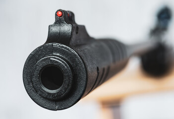 air rifle with an optical sight on a light background