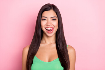 Fototapeta premium Photo of cute funny young lady wear green tank-top licking lips smiling isolated pink color background