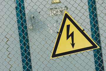 A protective network and signs warning of the danger of electric shocks