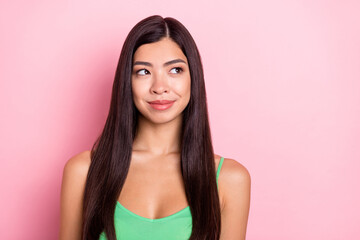 Fototapeta premium Photo of funny dreamy young lady wear green tank-top looking empty space smiling isolated pink color background