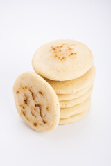Stack of arepas made with corn flour on a white background, typical Latin American food
