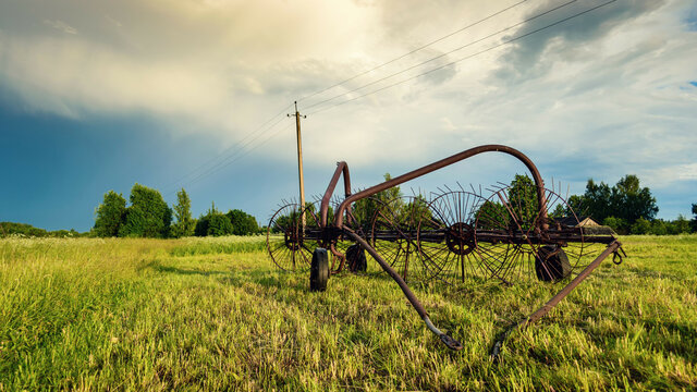 Old-time harvest machine. Old farm equipment. Hay-making