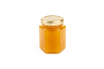 Glass jar full of sweet honey isolated on white background