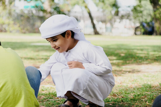Arab school boy learning with his classmate. Multicultural students at a school. Middle Easter school teaching home schooling. Closeup of Arabic child playing