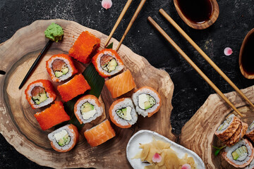 Sushi rolls California on wooden cut background. Concept delivery service. Japan food in eco container. Zero waste packaging. High quality photo