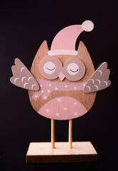 wooden owl toy decor on black background