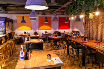 Interior of cozy restaurant in the modern style with open kitchen