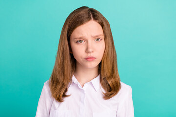 Fototapeta premium Portrait of attractive doubtful suspicious brown-haired preteen girl isolated over bright teal turquoise color background