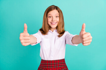 Portrait of attractive cheerful girl giving double thumbup ad isolated over vibrant teal turquoise color background