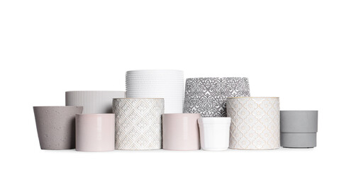 Different stylish ceramic flowerpots on white background