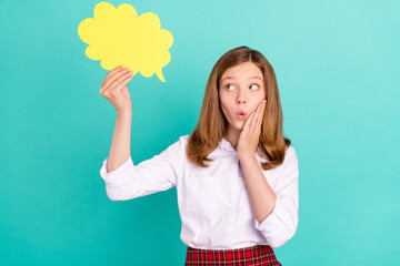 Portrait of attractive amazed girl holding paper cloud copy space pout lips news isolated over bright teal turquoise color background