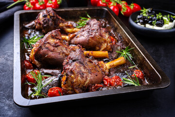 Traditional braised slow cooked Greek lamb shank in red wine sauce with eggplants and tomatoes...