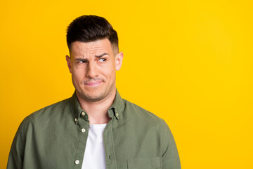 Photo portrait man wearing shirt looking copyspace unsure having doubt isolated bright yellow color...