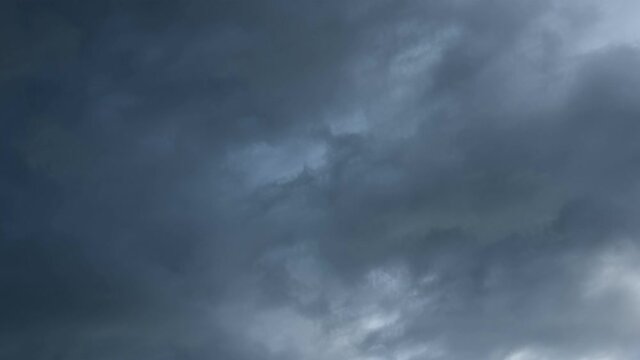 4K Time lapse, Gray and white rolling puffy clouds floating in the sky. Concept Storm Clouds Raining.