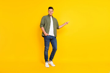 Fototapeta na wymiar Full length body size photo guy pointing copyspace isolated vibrant yellow color background