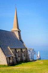 Fototapeta na wymiar Notre-Dame de la Garde chapel, the arch and the Needle in Etretat, Normandy