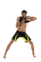 One man, professional male MMA boxer in motion isolated on white studio background. Fit muscular caucasian athlete fighting.