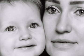 black and white close up portrait of young caucasian woman and baby daughter