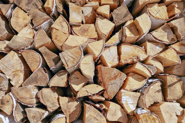 Folded birch firewood close-up. Wooden texture, background.