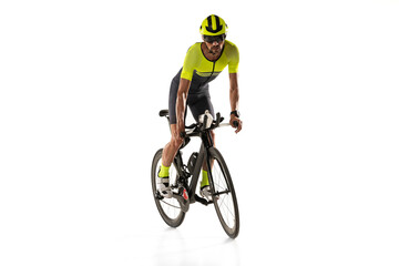 Fast and active. One young professional bicyclist, man on road bike isolated over white background.