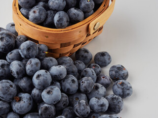 Blueberry fruit top view isolated on a white background, flat lay overhead layout with mint leaf, healthy design concept.