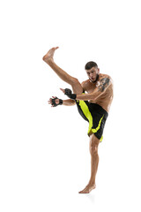 Professional male MMA boxer in motion isolated on white studio background. Fit muscular caucasian athlete fighting.