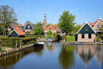 Obraz premium The historical town of Hindeloopen, Friesland, Netherlands, with historical houses, canals and the church