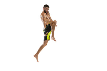 Professional male MMA boxer in motion isolated on white studio background. Fit muscular caucasian athlete fighting.
