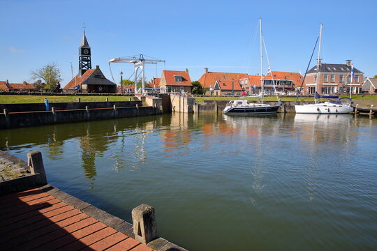 The harbor of the historical town of Hindeloopen, Friesland, Netherlands, with historical houses, sailing boats and a drawbridge