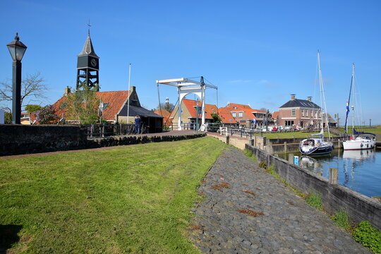 The harbor of the historical town of Hindeloopen, Friesland, Netherlands, with historical houses, sailing boats and a drawbridge