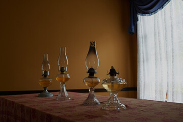 Oil Lamp Lighting up the Dark on a Wooden Table and with a Dark Background, Warm lighting
