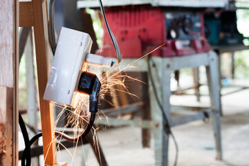 A short circuit causes a spark at the plug. Using non-standard power outlets old electrical...