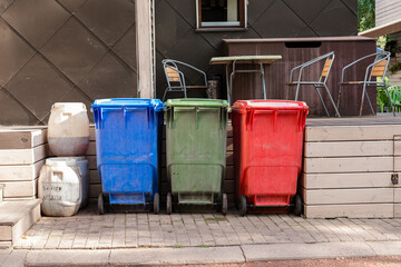 Separate waste collection bins in the park. Waste for processing, recyclable materials