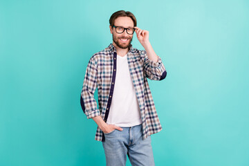 Photo of young handsome man happy positive smile confident hand touch glasses isolated over teal...